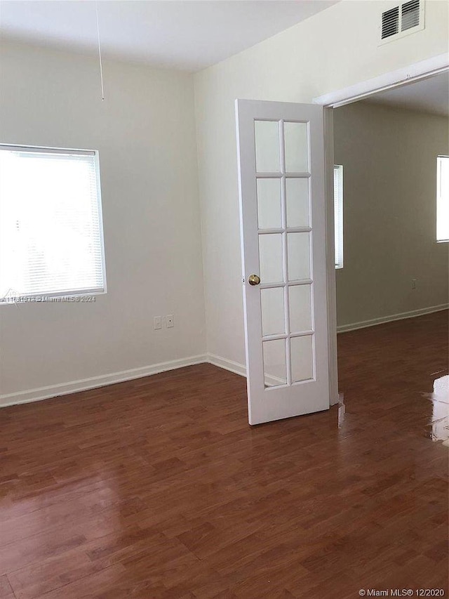 spare room featuring dark hardwood / wood-style floors