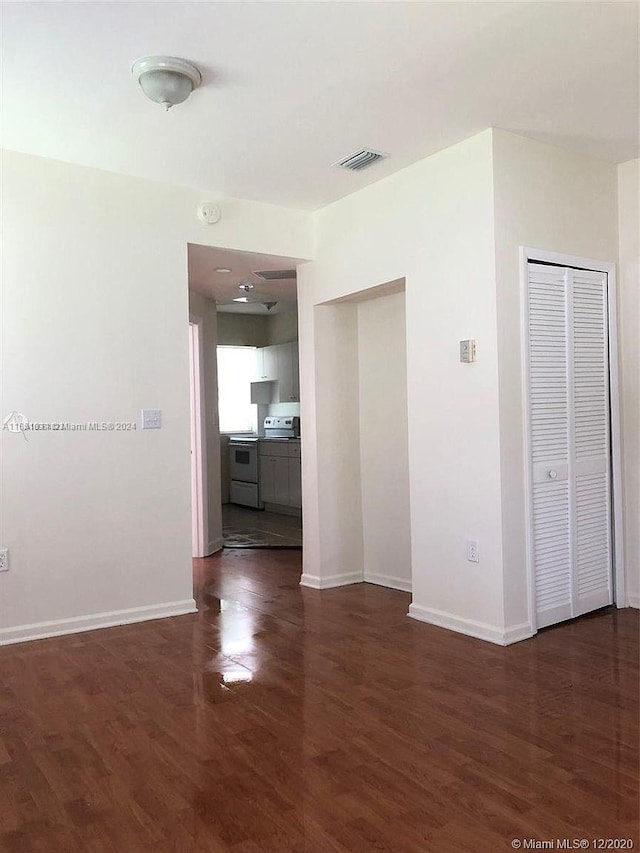 unfurnished room with dark hardwood / wood-style floors