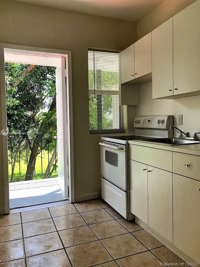 kitchen featuring a wealth of natural light and white range with electric stovetop