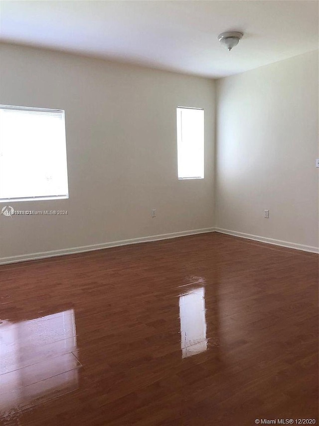 empty room featuring dark hardwood / wood-style flooring