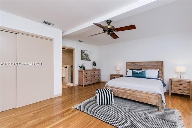 bedroom featuring wood-type flooring, ceiling fan, and a closet