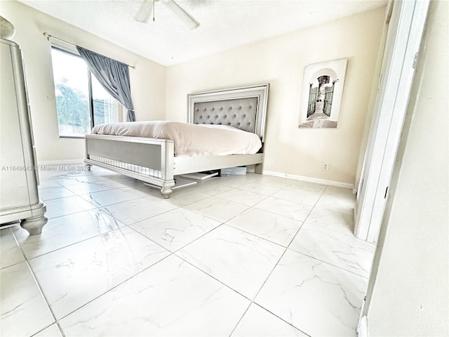 bedroom featuring ceiling fan and a textured ceiling