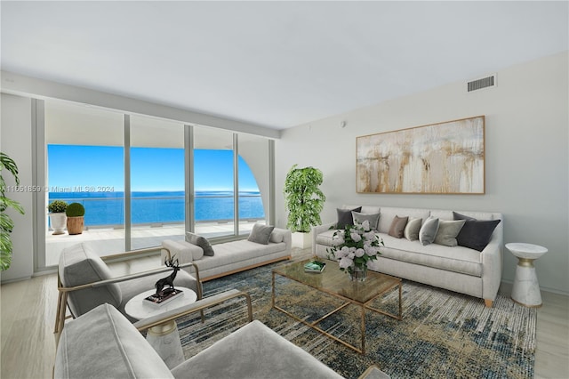 living room with a water view and hardwood / wood-style flooring