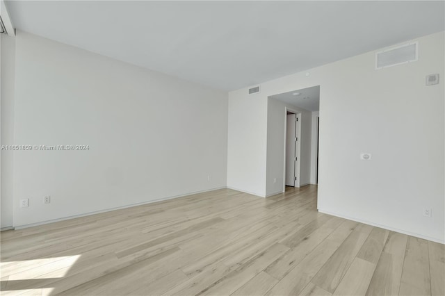 spare room featuring light hardwood / wood-style floors