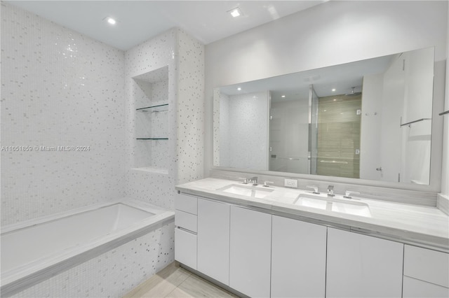 bathroom featuring vanity and plus walk in shower