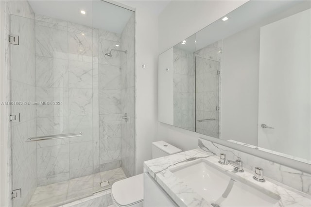 bathroom with vanity, toilet, and an enclosed shower