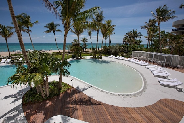 view of pool with a water view