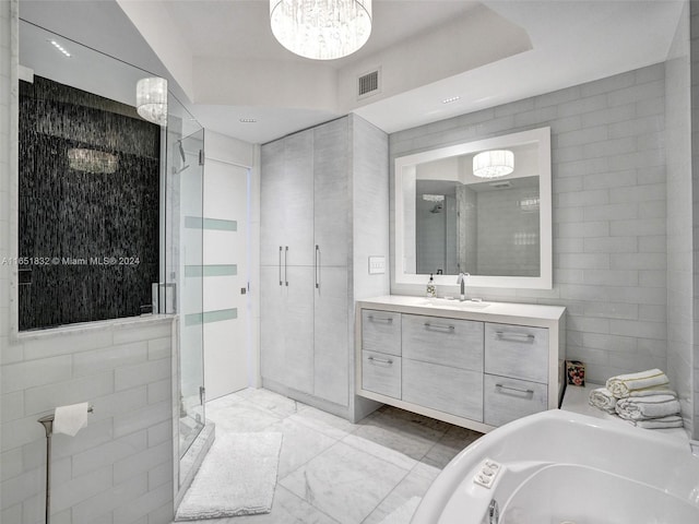 bathroom with vanity, tile walls, and plus walk in shower