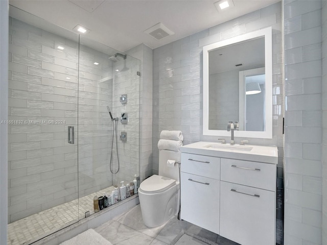 bathroom with a shower with door, vanity, and toilet