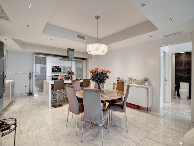 dining space with a tray ceiling