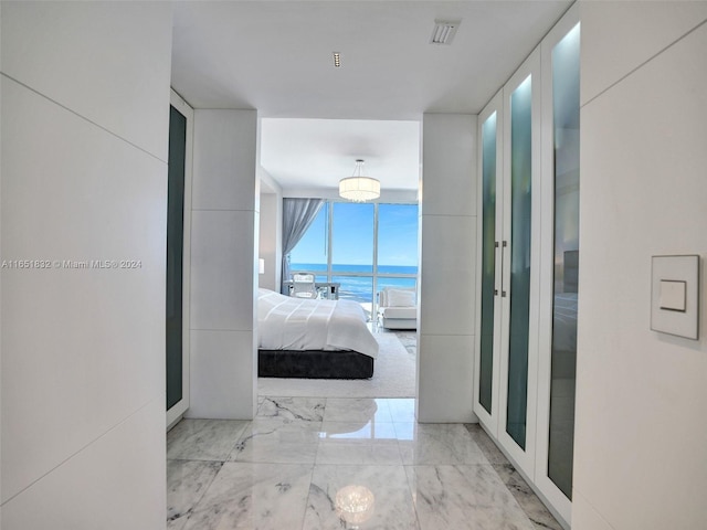 hallway featuring expansive windows and a water view