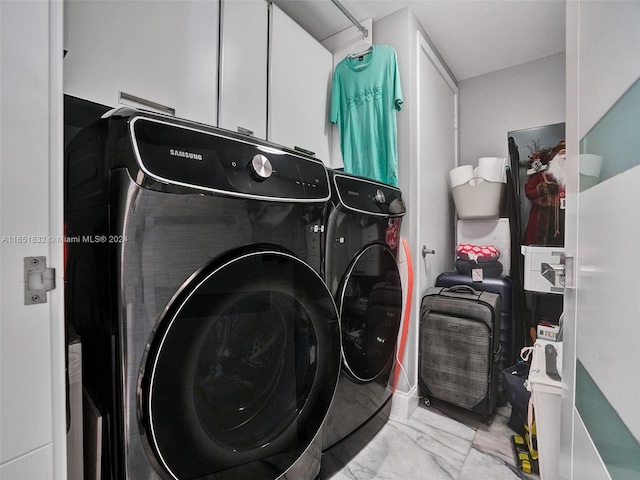 laundry room with cabinets and washing machine and dryer