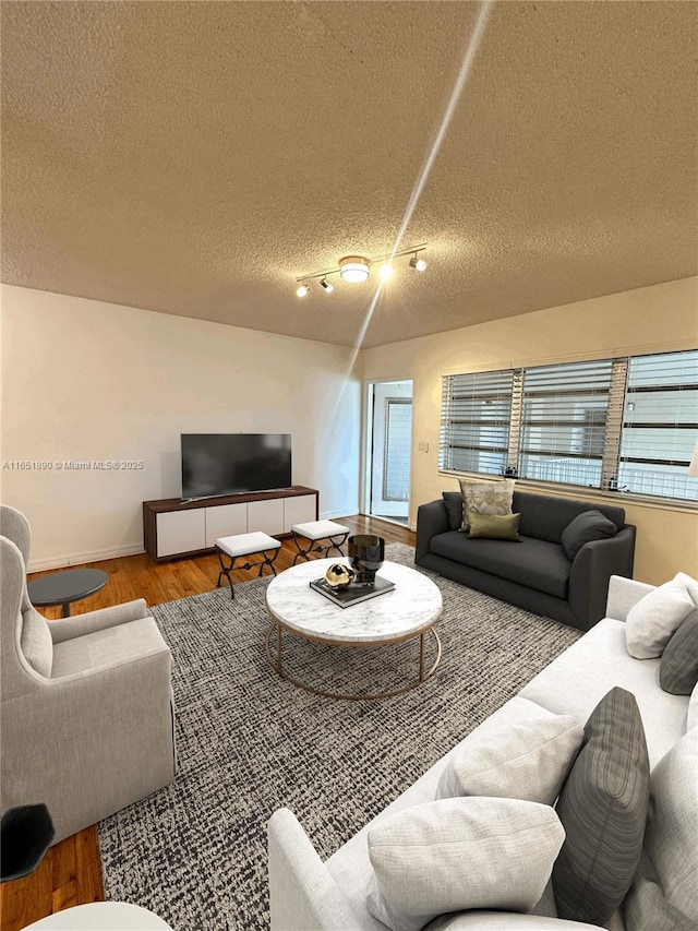 living room featuring a textured ceiling and light hardwood / wood-style floors