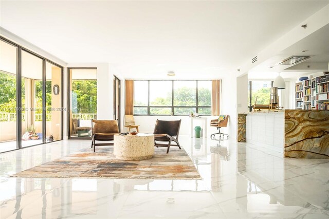 living room with a wealth of natural light and floor to ceiling windows