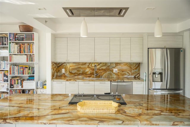 kitchen featuring sink, light stone countertops, appliances with stainless steel finishes, and decorative backsplash