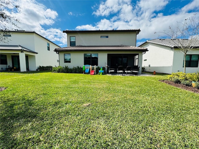 8123 NW 78th St, Tamarac, FL 33321 - rear view of property featuring a yard, stucco siding, and a sunroom
