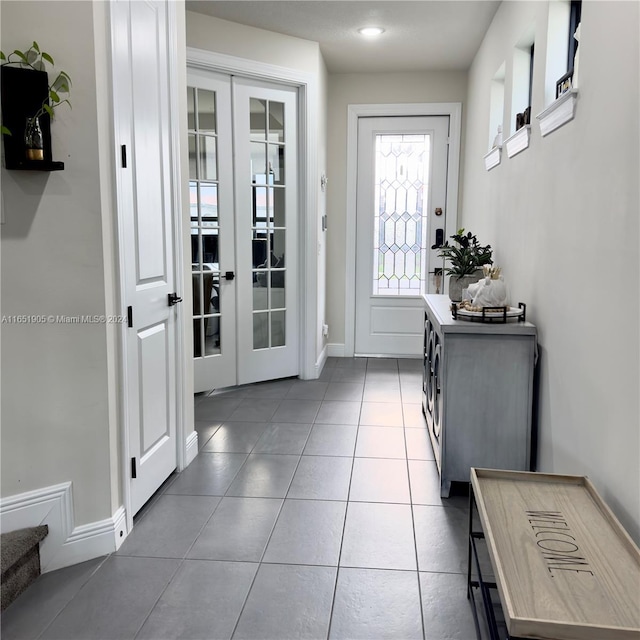 8123 NW 78th St, Tamarac, FL 33321 - doorway with french doors, baseboards, and tile patterned flooring