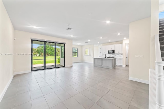 8123 NW 78th St, Tamarac, FL 33321 - unfurnished living room featuring light tile patterned floors, recessed lighting, and stairway