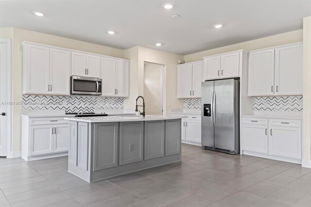 8123 NW 78th St, Tamarac, FL 33321 - kitchen featuring appliances with stainless steel finishes, backsplash, light countertops, white cabinets, and recessed lighting