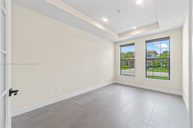 8123 NW 78th St, Tamarac, FL 33321 - tiled spare room featuring a tray ceiling and recessed lighting