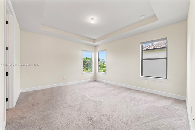 8123 NW 78th St, Tamarac, FL 33321 - carpeted empty room with a tray ceiling and baseboards