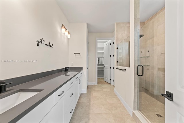 8123 NW 78th St, Tamarac, FL 33321 - bathroom with a stall shower, double vanity, a spacious closet, and tile patterned floors