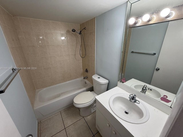 full bathroom featuring tiled shower / bath, vanity, toilet, and tile patterned floors