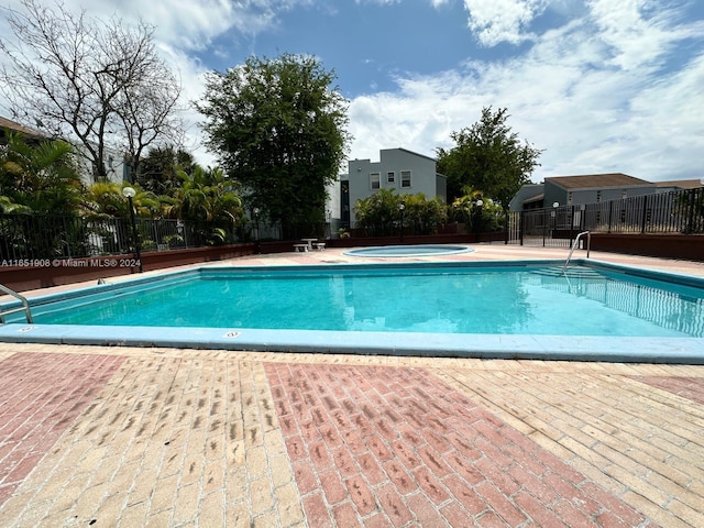 view of swimming pool with a patio