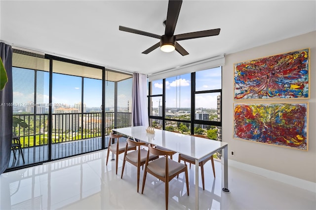 tiled dining space with a wealth of natural light, floor to ceiling windows, and ceiling fan