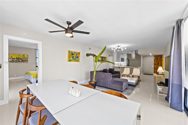 dining space featuring ceiling fan with notable chandelier