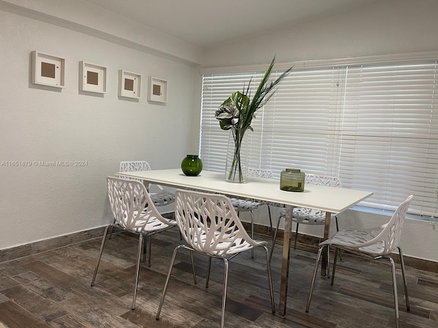 dining room featuring dark hardwood / wood-style flooring and lofted ceiling