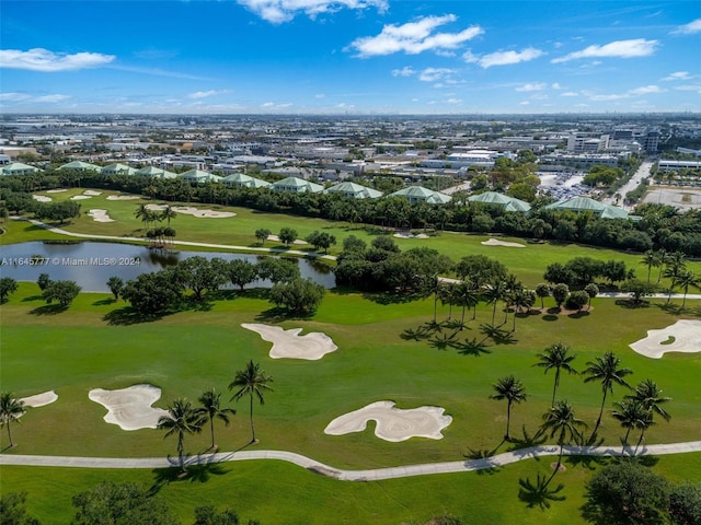 drone / aerial view featuring a water view, golf course view, and a residential view