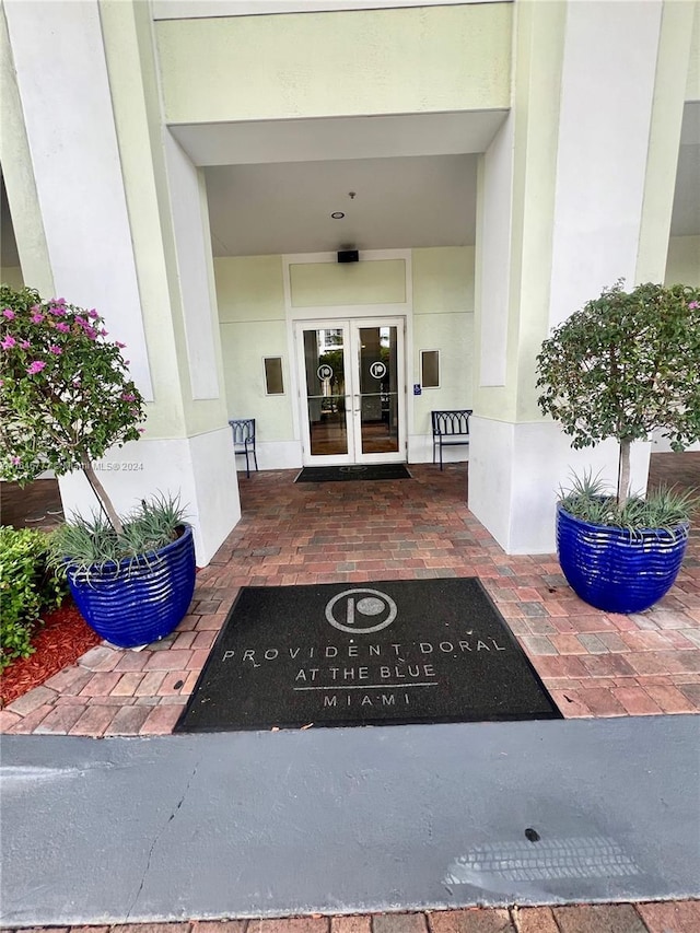 property entrance featuring french doors and stucco siding