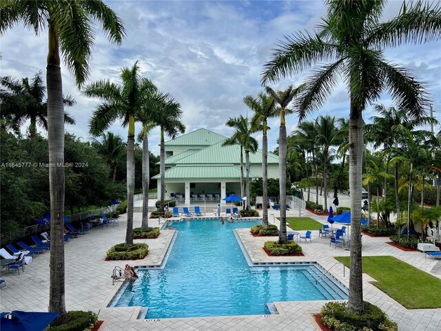 pool with a patio and fence