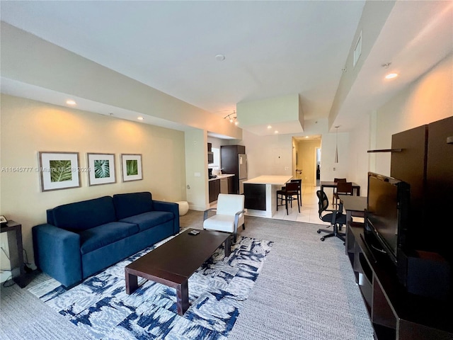 living room featuring visible vents, recessed lighting, and light colored carpet