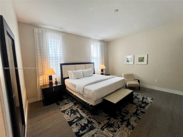 bedroom featuring dark carpet