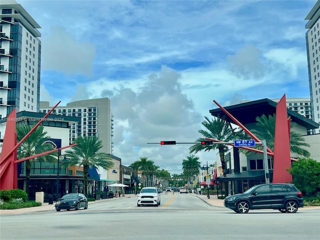 view of road featuring curbs, traffic lights, and sidewalks