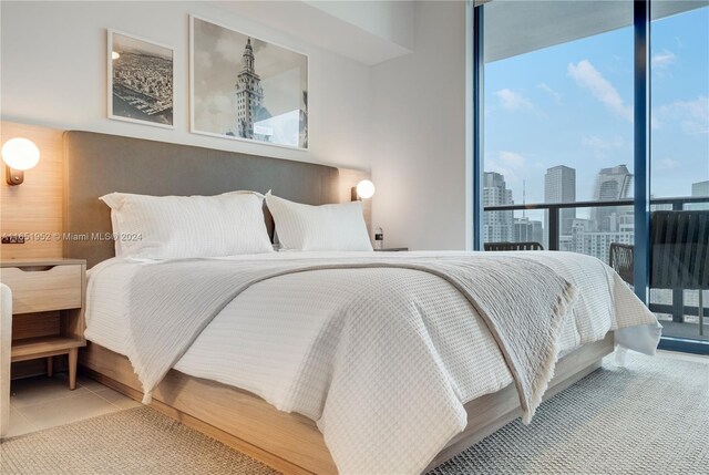 tiled bedroom with expansive windows and multiple windows