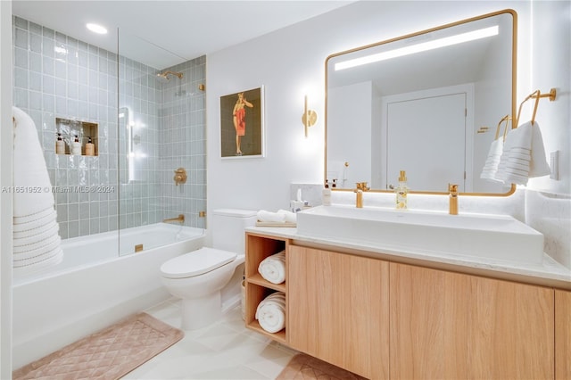 full bathroom with tile patterned floors, toilet, tiled shower / bath combo, and vanity