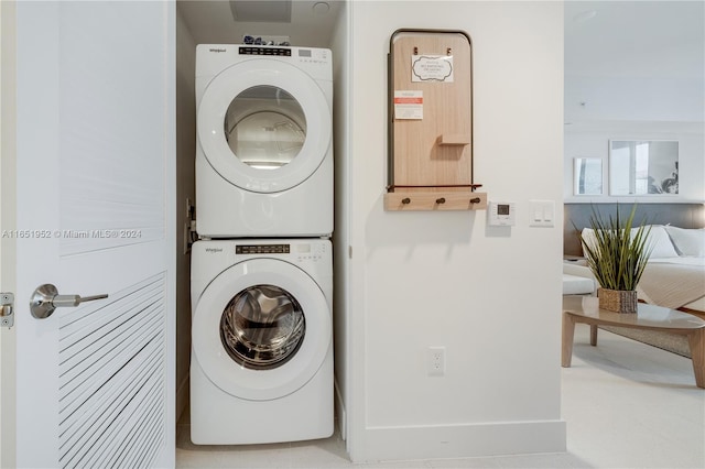 clothes washing area with stacked washer / drying machine