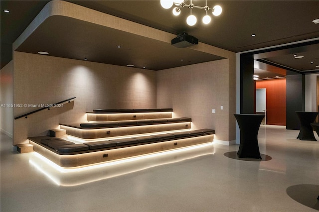 home theater room featuring an inviting chandelier