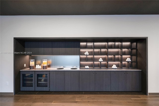 bar featuring hardwood / wood-style flooring and beverage cooler