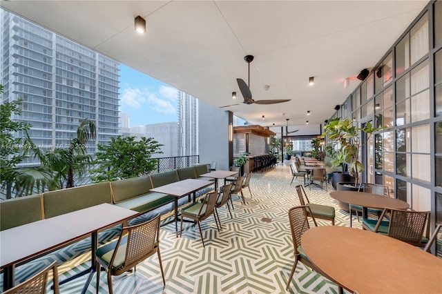 interior space with outdoor lounge area, ceiling fan, and a balcony