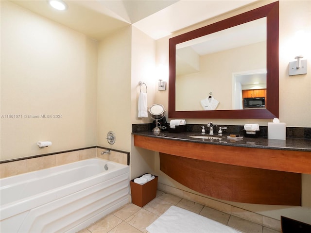 bathroom with vanity and a bath