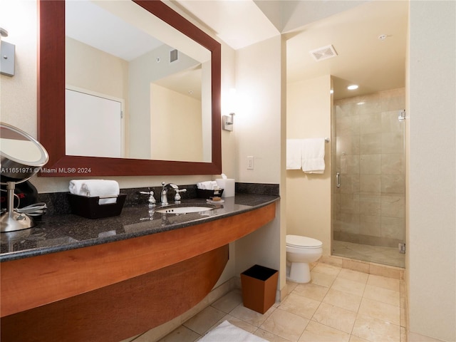 bathroom featuring walk in shower, tile patterned flooring, sink, and toilet