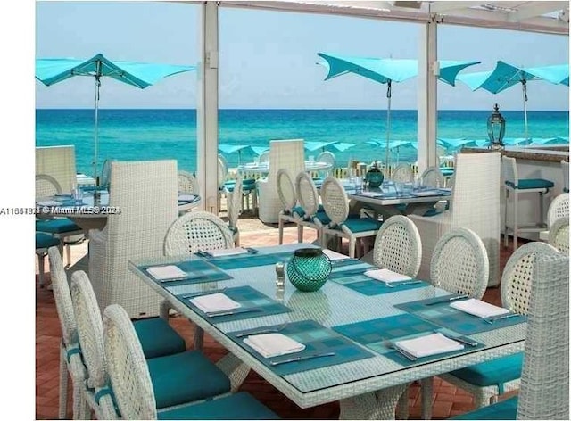 dining room with hardwood / wood-style floors and a water view