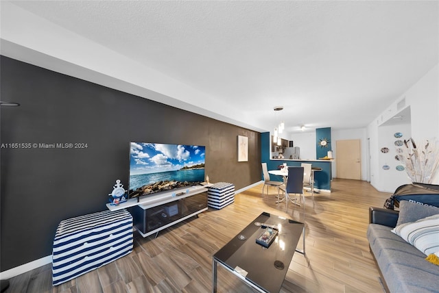 living room with a textured ceiling and hardwood / wood-style flooring