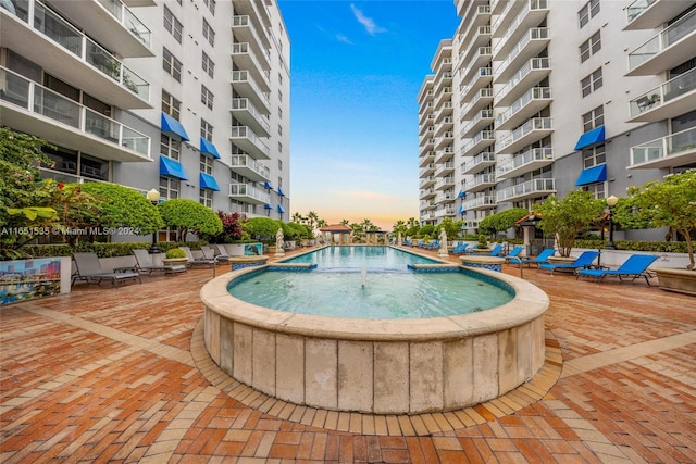 pool at dusk with pool water feature