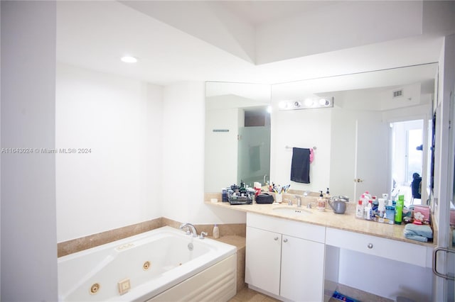 bathroom featuring vanity and separate shower and tub