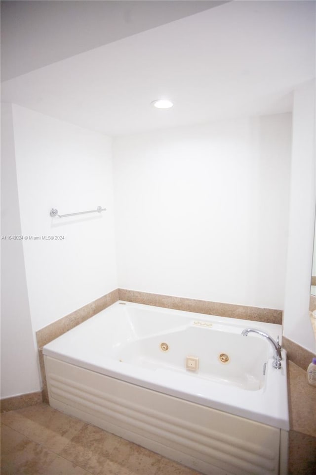 bathroom featuring tile patterned floors and a washtub